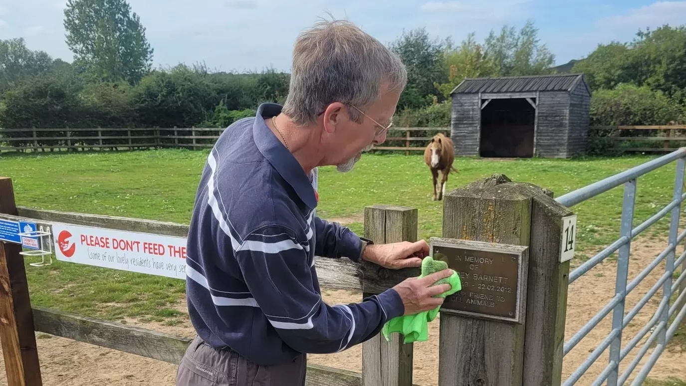 A man cleaning plaques at a Redwings centre