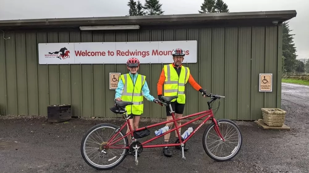 Fundraisers Izzy and Richard took on a sponsored tandem bike ride for Redwings, pictured setting off at Redwings Mountains.