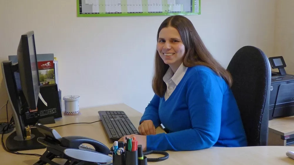 Katie sitting at her desk