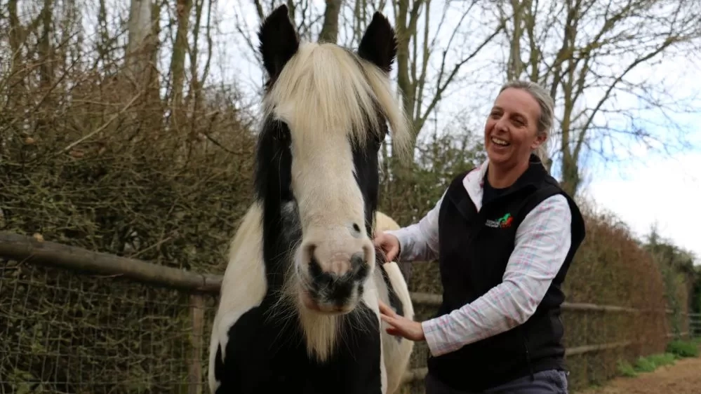 Nursing Manager Lou gives black and white pony Audrey a scratch