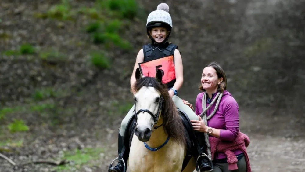 Redwings Brina, her young rider and her mum running alongside