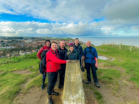 A group of men and women walking the coast path for Redwings