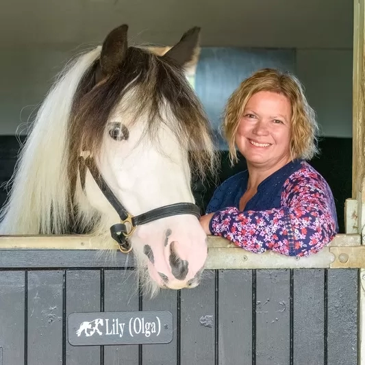 A pony with her loving guardian