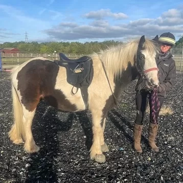 Pony standing with trainer at Redwings