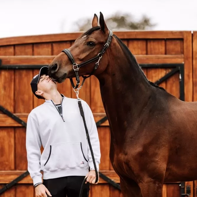 Showjumper Joe Stockdale stood next to his horse, who is kissing him