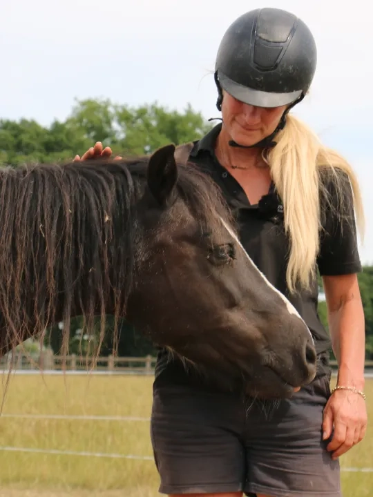 Photo of Pansie the horse with carer. 