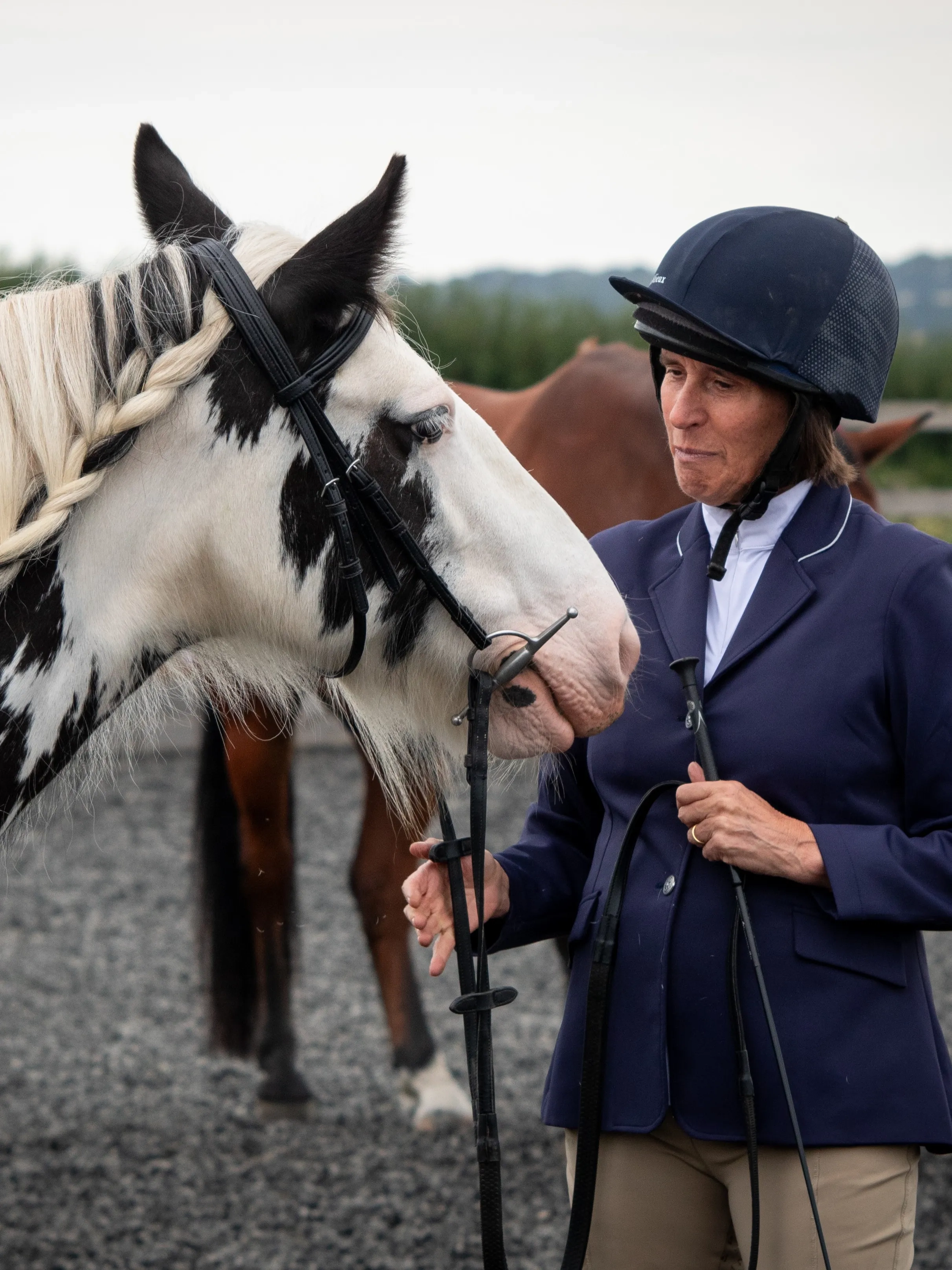 Photo of Sue stood with her rehomed Redwings horse Estelle before a show.