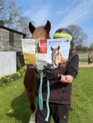 Dennie is reading the Redwings the newsletter with his carer Andy